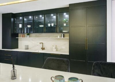 Mangan Woodcraft Contemporary kitchen with black doors and brass handles and fixings